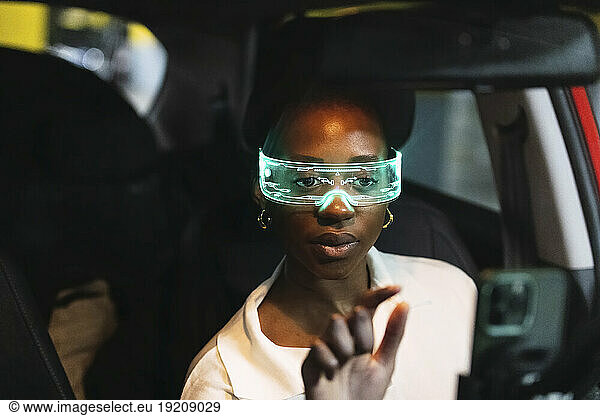 Businesswoman wearing smart glasses using smart phone in car