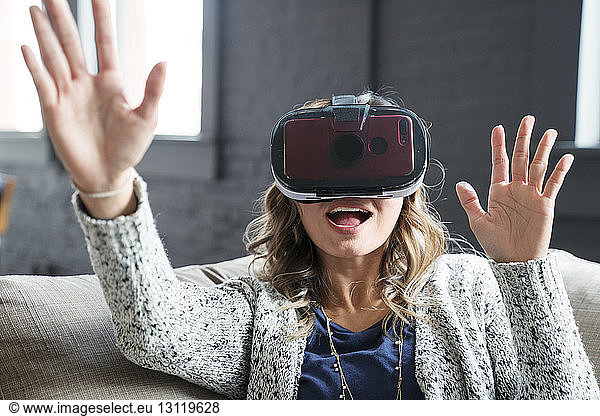 Businesswoman wearing virtual reality simulator in office