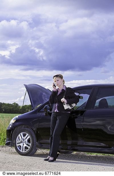 Businesswoman with car trouble on a rural road Pembina Valley Manitoba