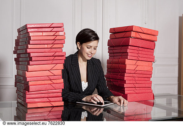 Businesswoman with stacks of folders