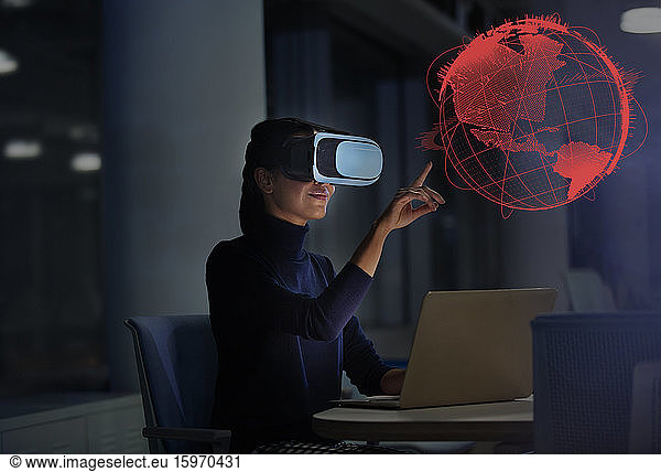 Businesswoman with virtual reality glasses touching virtual globe