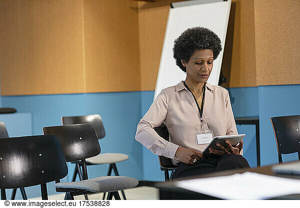 Businesswoman working on tablet PC in office board room