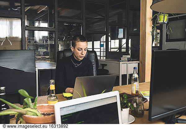 Businesswoman working over laptop at workplace