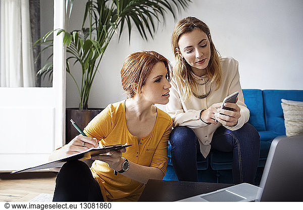 Businesswomen planning while sitting in creative office