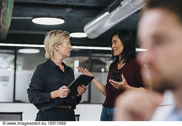 Businesswomen planning with each other at work place