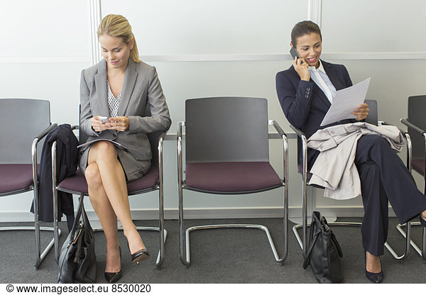 Businesswomen sitting in waiting area
