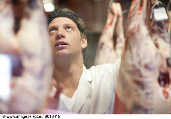 Butcher inspecting meat