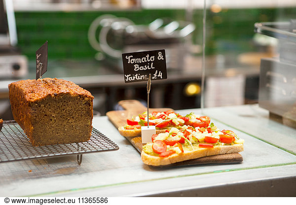 Cafe display cabinet with cake and open sandwiches