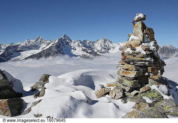 Cairn and snowy peaks  Valais Alps   Switzerland.