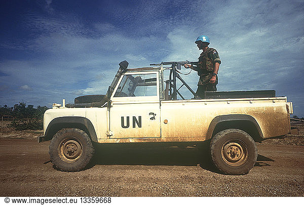 CAMBODIA Thmar Pouk Dutch made UN jeep with a soldier standing behind a mounted rifle in the back.