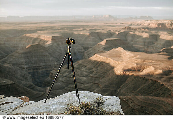 camera and tripod on cliff edge in front of scenic view  Utah desert
