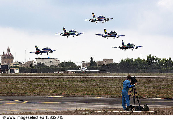 Cameraman film an aerobatic squad landing at Luqa airfield in Malta