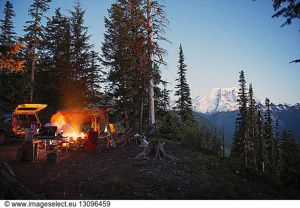 Camp fire on cliff by trees at North Cascades National Park