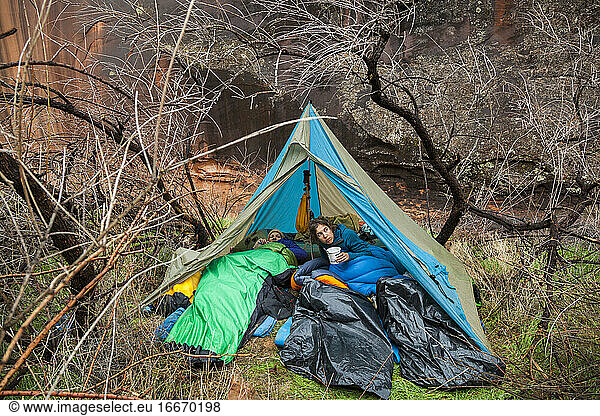 Campers emerge from tent after rain near Escalante River  Utah
