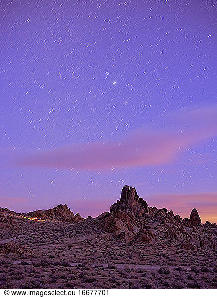 Campers on a ridge  star trails in the sky  Alabama Hills.