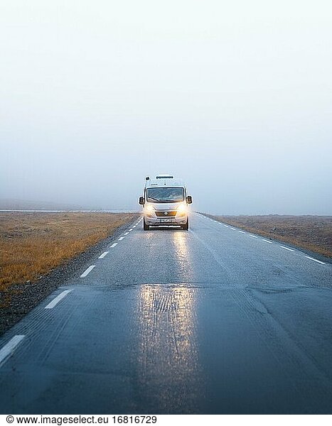 Campervan with bright lights on a road near the North Cape  North Cape  Norway  Europe