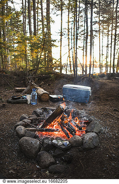 Campfire at sunset while car camping in coastal Maine