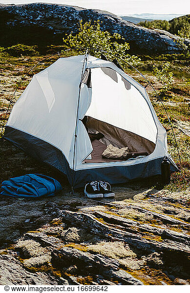 Camping tent set on a rocky terrain