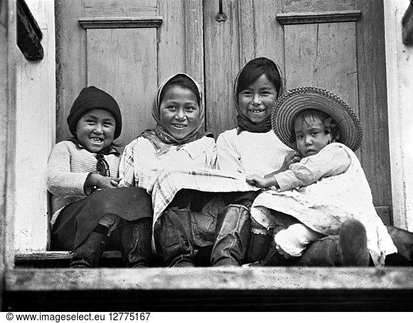 CANADA: ESKIMOS. A group of four Eskimo children sitting in front of a doorway in Hopedale  Labrador  Canada. Photograph  c1925.