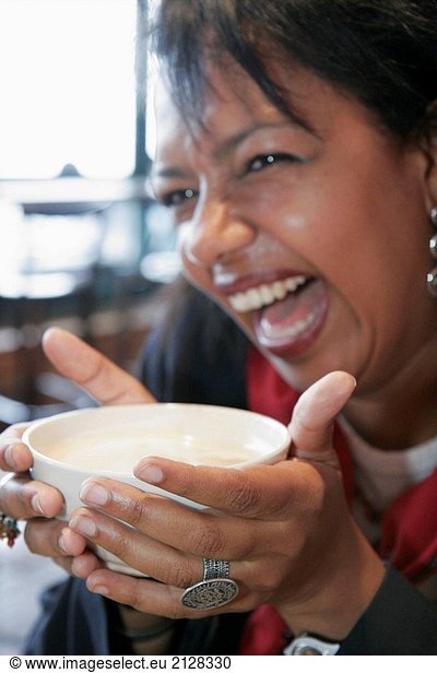 Canada  Montreal  Atwater Market  Boulangerie Premiere Moisson  Black woman drinks caffe latte  coffee  milk  bowl