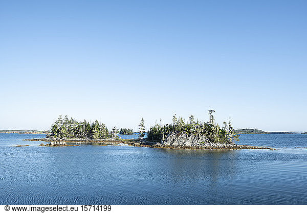 Canada  Nova Scotia  Mitchell Bay  Clear sky over small forested islands