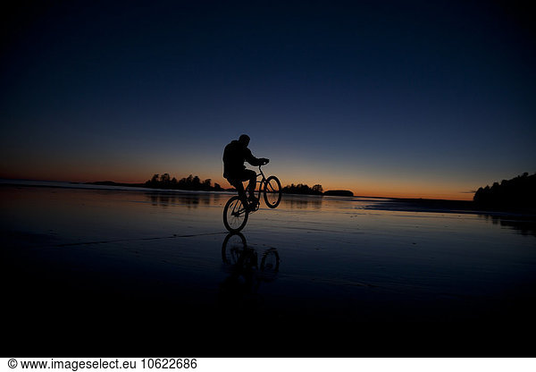 Canada  Vancouver Island  Longbeach  Man biking at the beach