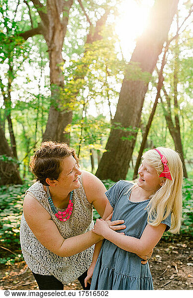 Candid portrait of a mother and daughter laughing together