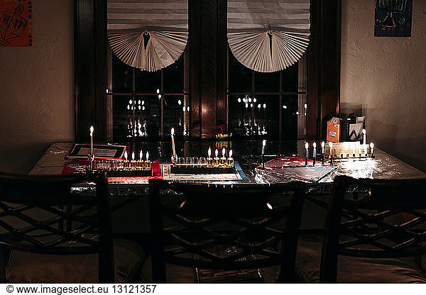 Candles decorated on table in darkroom during Hanukkah