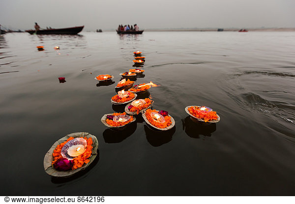 Candles floating in the Ganges River  Varanasi  India