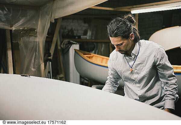 Canoe builder at a small wood workshop  self organised production
