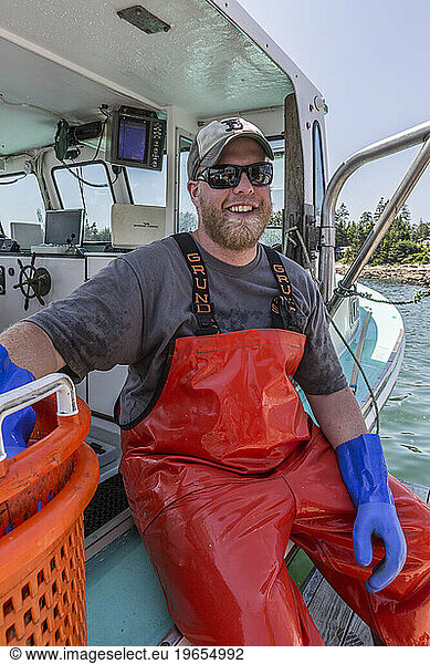 Captain Cole Baines aboard 'Jackpot' at the Spruce Head Fisherman's Co-op in South Thomaston  Maine.