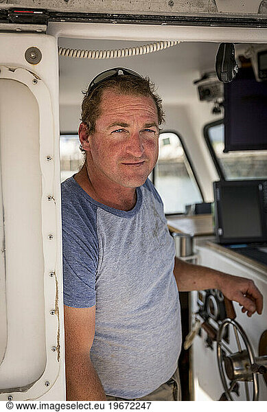 Captain Ivan Bly aboard his lobster boat 'Iris-Irene' at the Tenants Harbor Fisherman's Coop in Tenants Harbor  Maine.