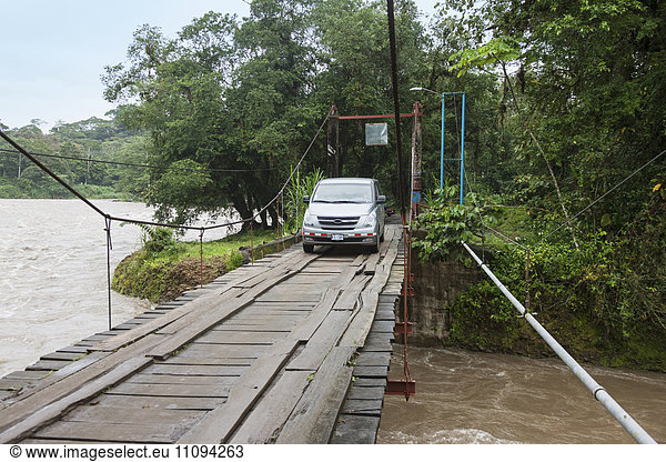 Car crossing Sarapiqui River by bridge  Costa Rica