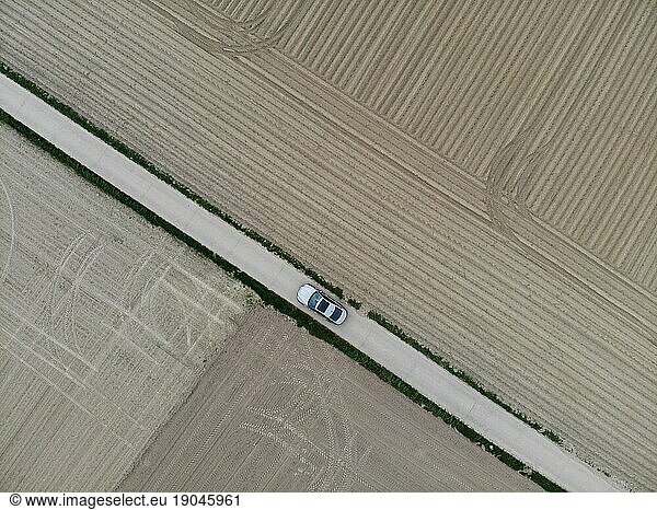 car drive through farm land with fields