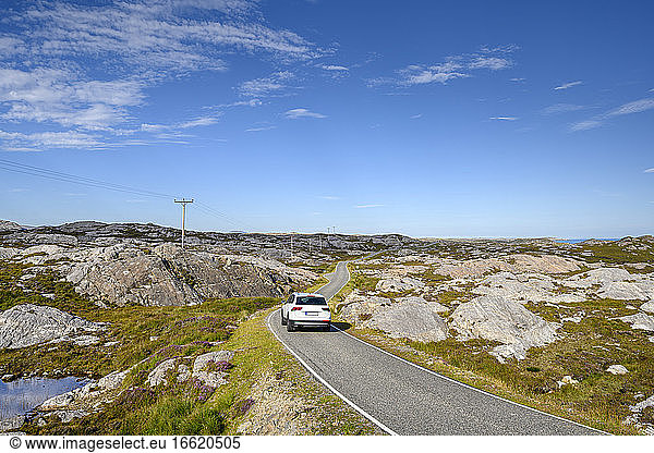Car driving along Golden Road on Isle of Harris
