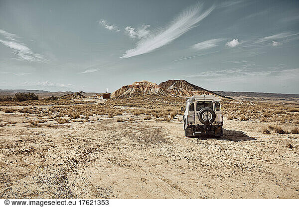 Car driving in desert landscape  Bardenas Reales  Spain