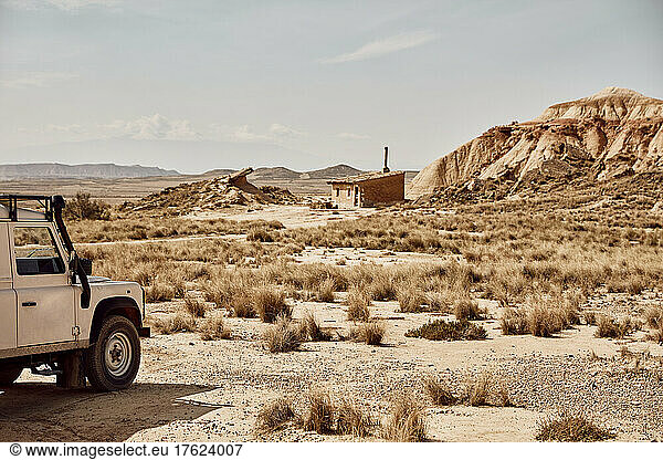 Car in desert area on sunny day  Bardenas Reales  Spain