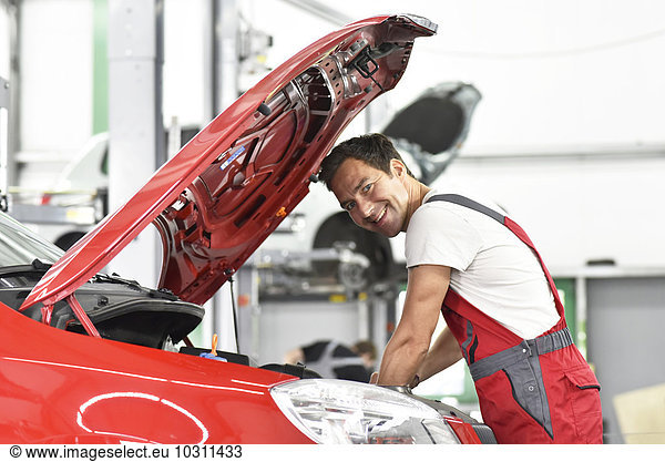 Car mechanic working in repair garage