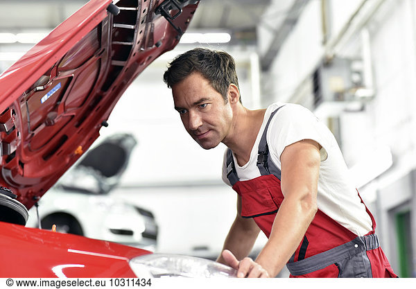 Car mechanic working in repair garage