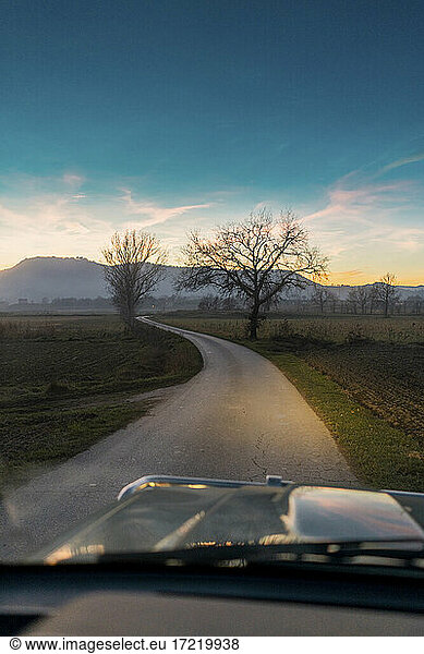Car on country road during sunset