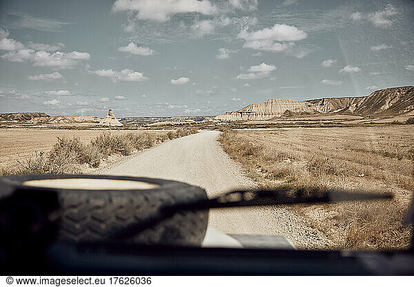 Car on dirt road in desert area at Bardenas Reales  Spain
