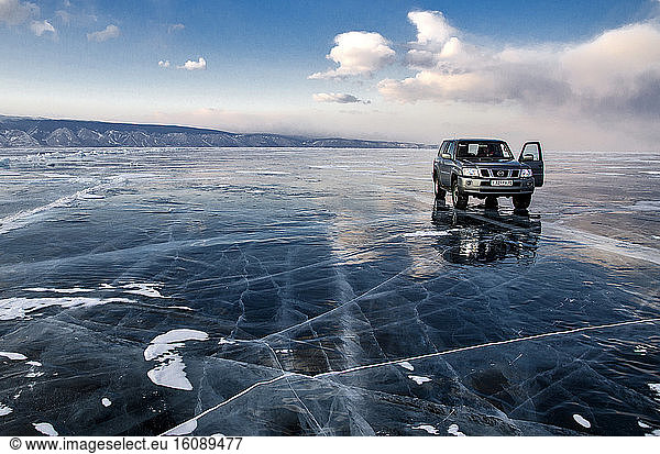 Car on ice on the surface of Lake Baikal Car on ice on the surface of ...