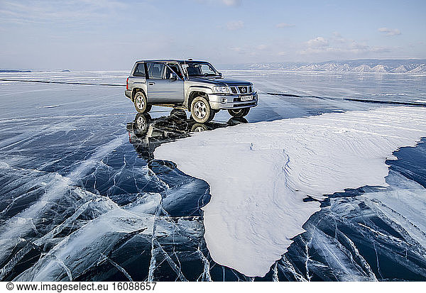 Car on ice on the surface of Lake Baikal  Siberia  Russia