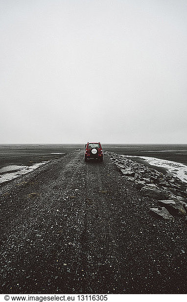 Car on road against clear sky