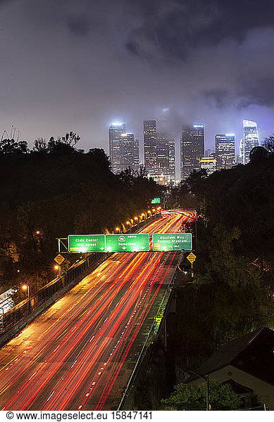 Car Streak By Bridges and Freeway on Foggy Night in Downtown LA