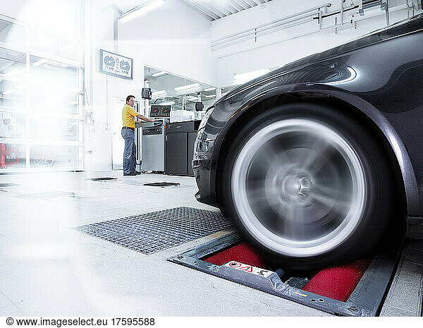 Car tire test with technician at automobile industry