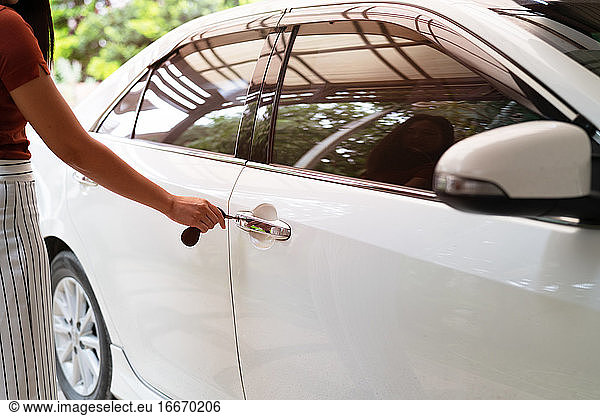 car unlocks  woman use key to open the car door