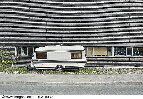 Caravan and wooden wall