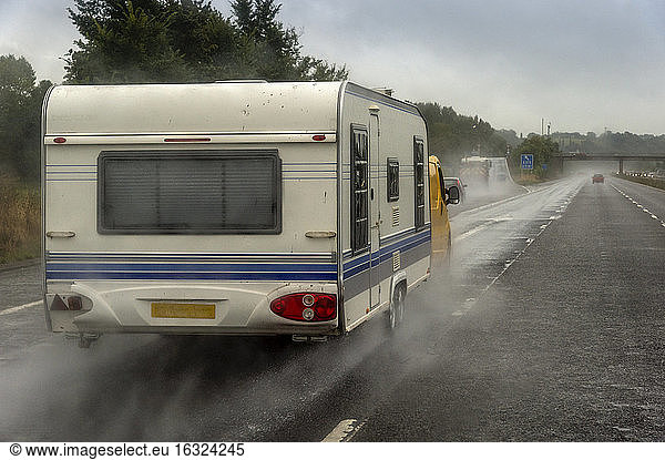 Caravan on motorway in rain