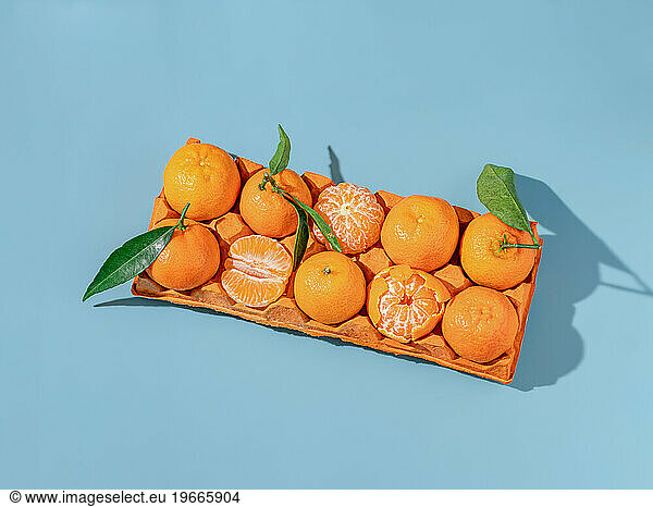 Cardboard egg tray with tangerines. Creative new year's still life
